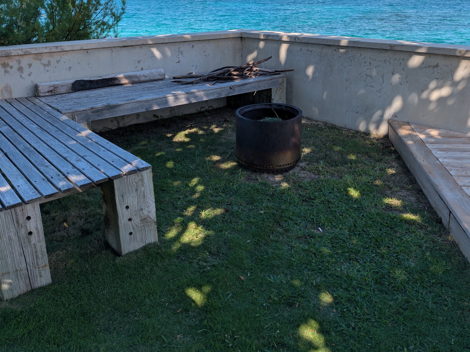 The fire pit and benches by the sea wall